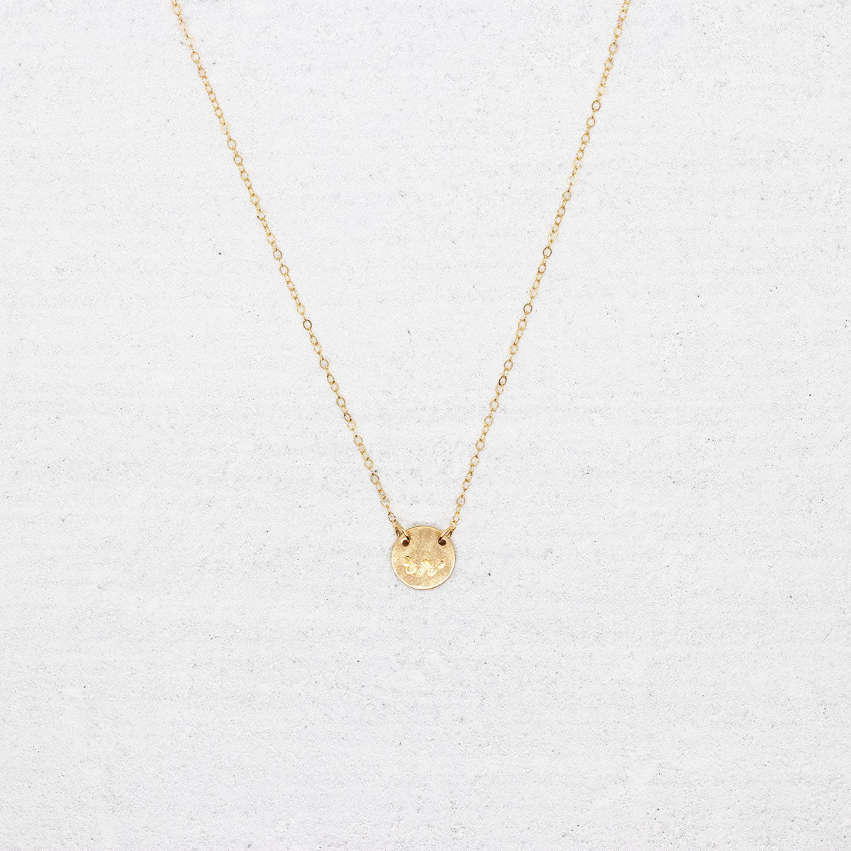 Minimalist, gold-filled necklace stamped with a vine
