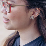 Rainbow earring made out of wood. Purchases support women who have aged out of foster care.